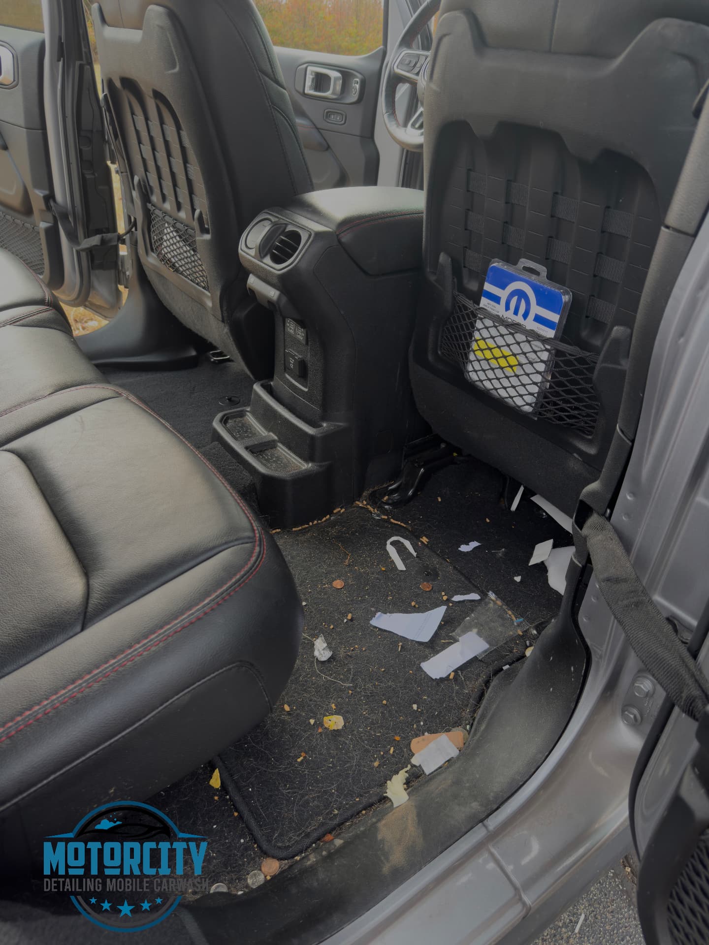 Debris-covered vehicle interior before a full interior detail