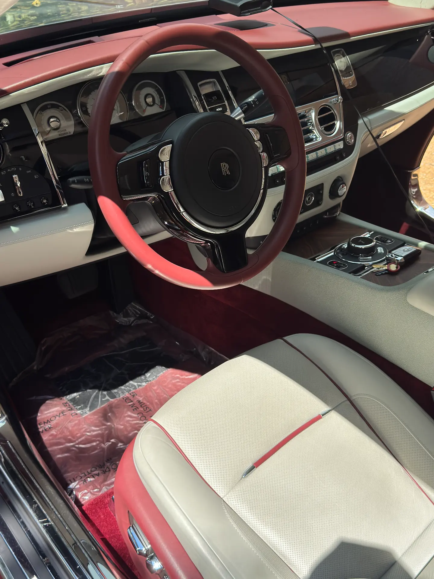 Rolls-Royce Wraith cockpit with cleaned red steering wheel, dash and cream leather