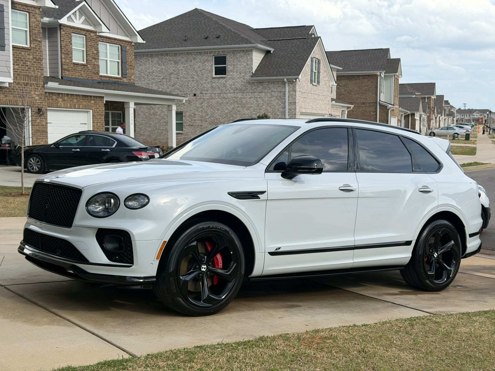 White Bentley Bentayga detailed in a driveway after a Motorcity Detail package